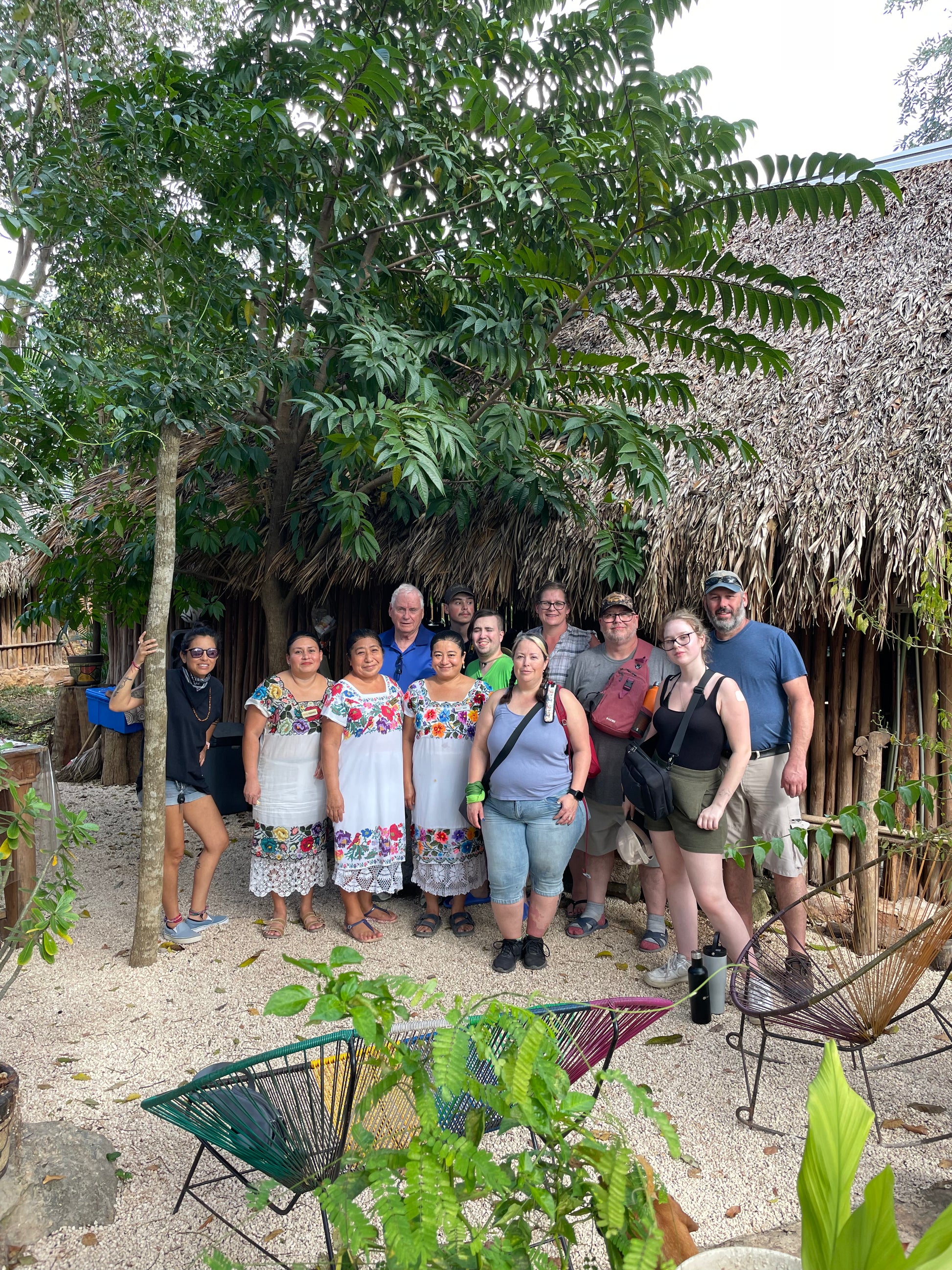 Small group of travelers with Maya women of Aldea Xbatún, Yucatán