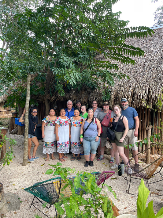 Small group of travelers with Maya women of Aldea Xbatún, Yucatán