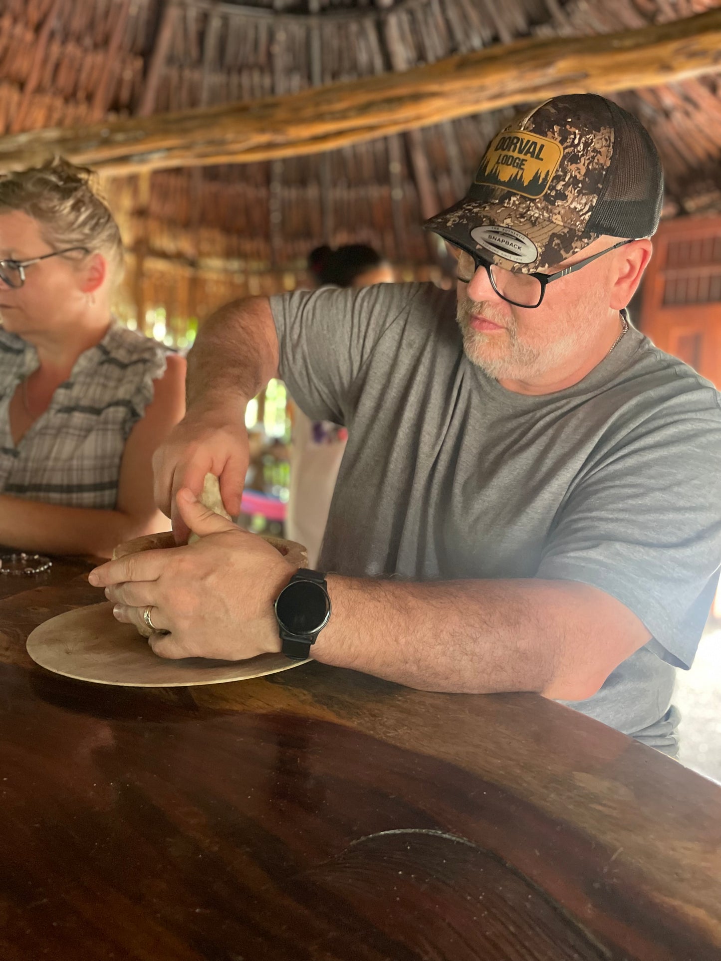 Traveler making tortillas by hand with a Maya family, Crossing Yucatán journey