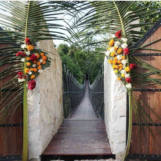 Decorative wooden gates with floral arrangements on a suspension bridge